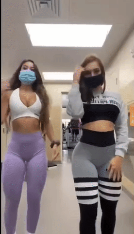 Two Hotties in Tights and Masks Walking Down the Hallway picture 1 of 1