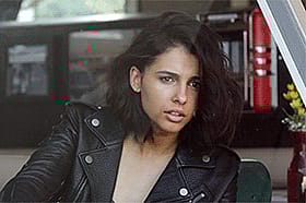 Naomi Scott's Sultry Brunette: A Celebrity's Seductive Gaze'