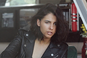 Naomi Scott's Sultry Brunette: A Celebrity's Seductive Gaze picture 1 of 1