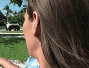 Sexy Chick in Blue Shirt Looking at Jeep picture 1 of 1