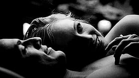 Sexy Smile: Two People Laying in Bed'