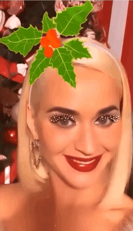 Blonde Celebrity Smiling with Red Lipstick and Christmas Tree Decoration picture 1 of 1